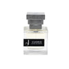 Flacone trasparente di profumo Cuorio Extrait de Parfum con tappo geometrico grigio